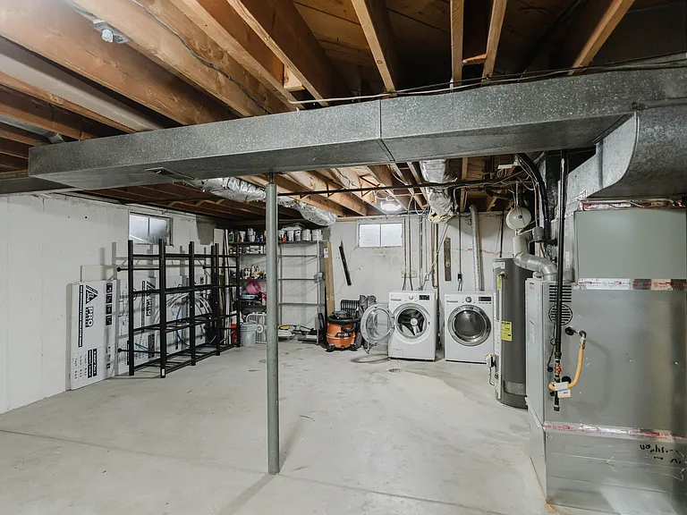 Unfinished basement with washer and dryer