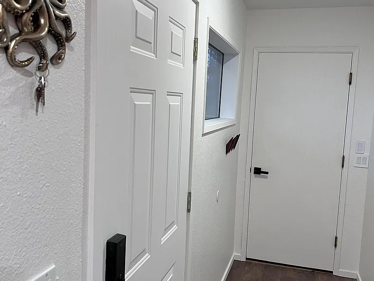Main door is on the left. Door to garage is straight ahead