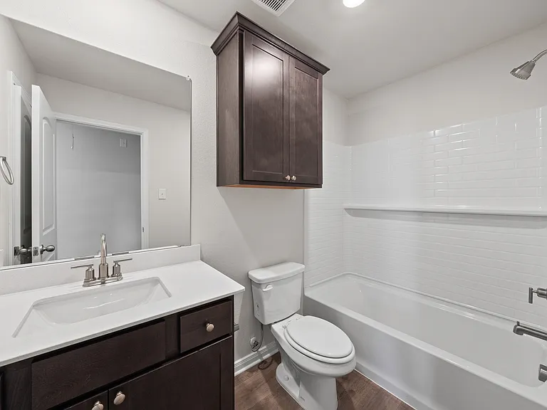 The secondary bathroom has a wonderful vanity space and a shower-tub combo.