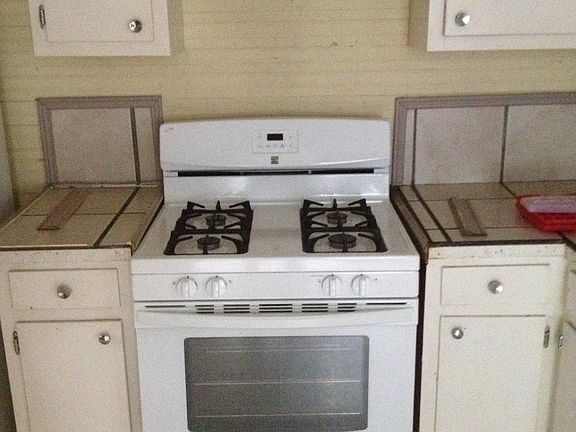 Kitchen range, tile countertops.