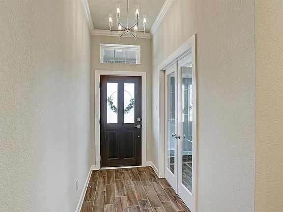 Inviting entry with mahogany door, and beautiful Chestnut Harbour tile floors.
