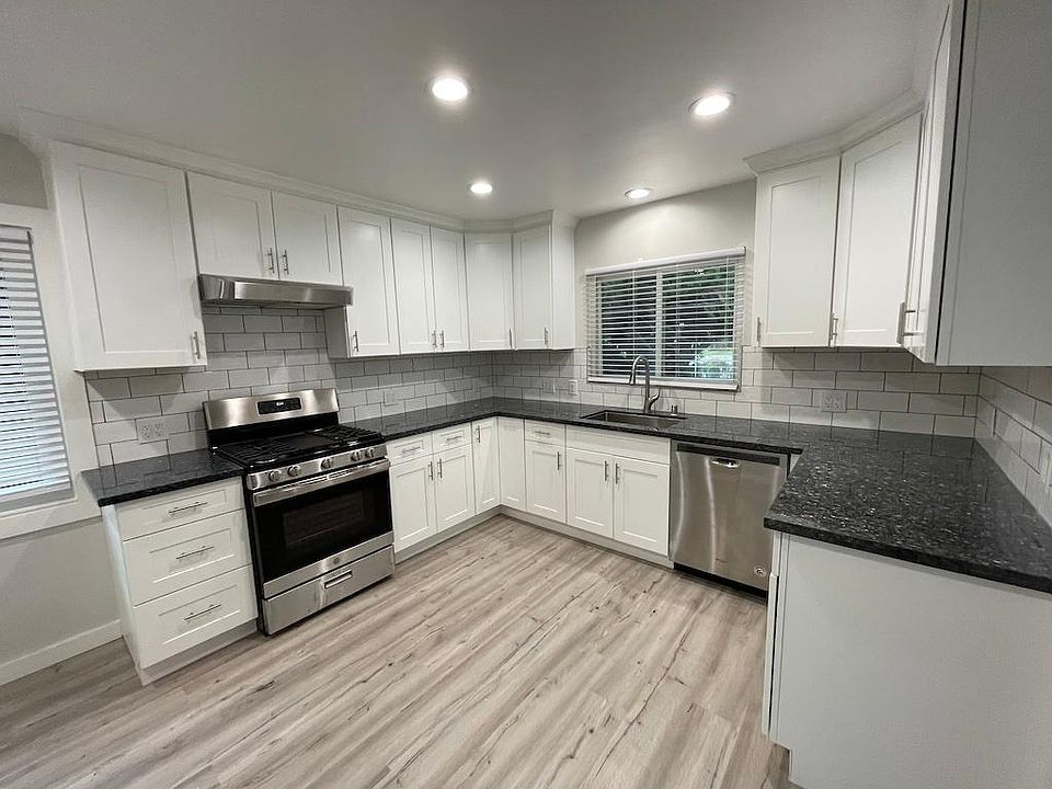 Newly remodeled kitchen with gas stove and dishwasher.