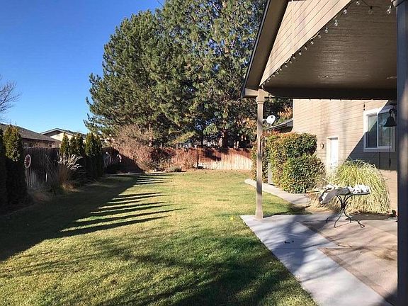 Fully fenced backyard with a covered patio.