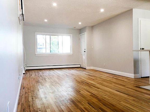 Photo of the living room & the front door. The door on the far right is a large walk in closet off the kitchen. There is also a seperate pantry next to that closet as well.