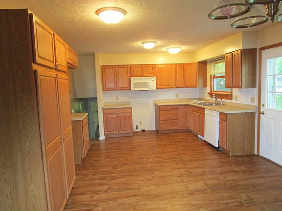 Kitchen is newly remodeled with large panyry cabinets.