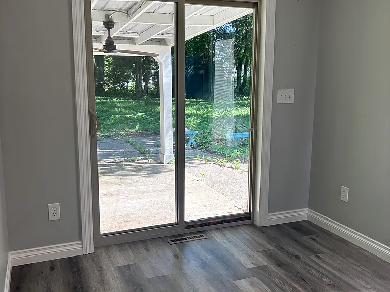 Bedroom with sliding glass door to backyard