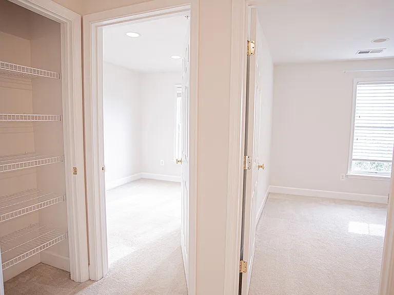 2 additional bedrooms and a linen closet with shelving