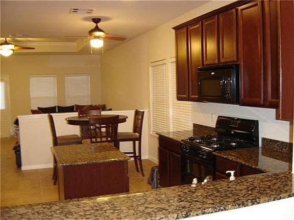 RAISED GRANIT BAR GIVES A VIEW INTO THIS GRAND KITCHEN