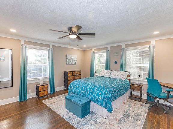 Queen bed with luxury bedding and room-darkening curtains for shift workers.