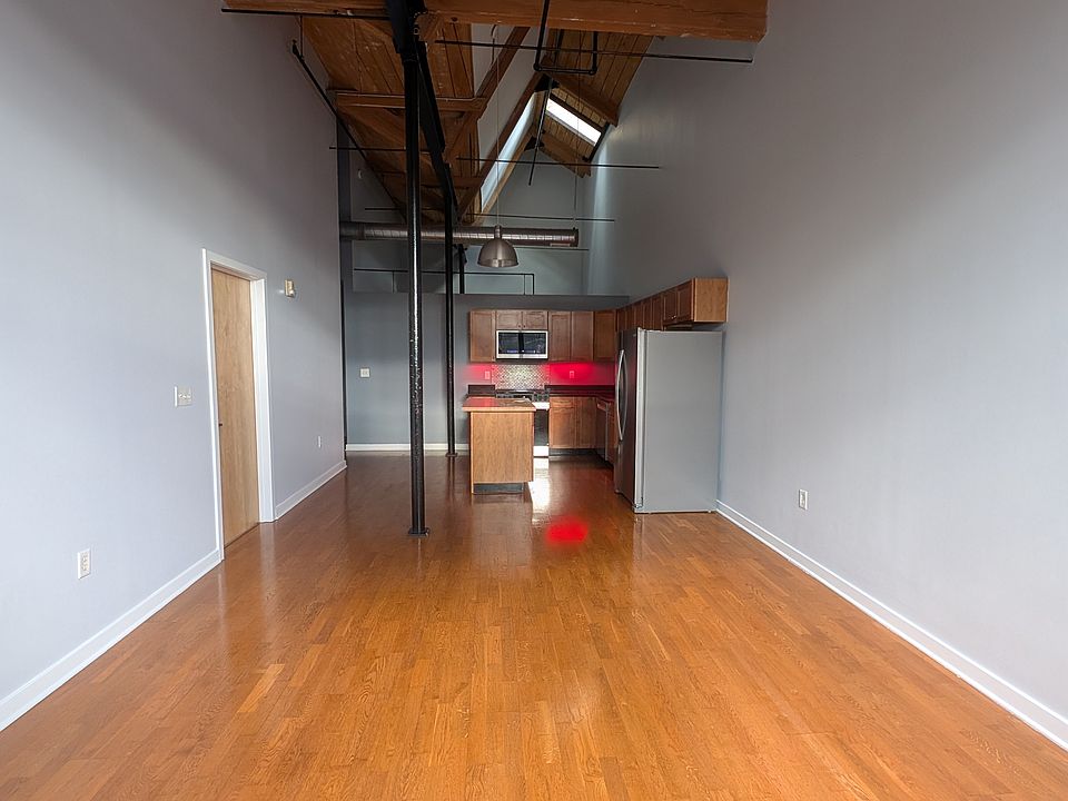kitchen, living room, dinning room showing 27' high ceilings.