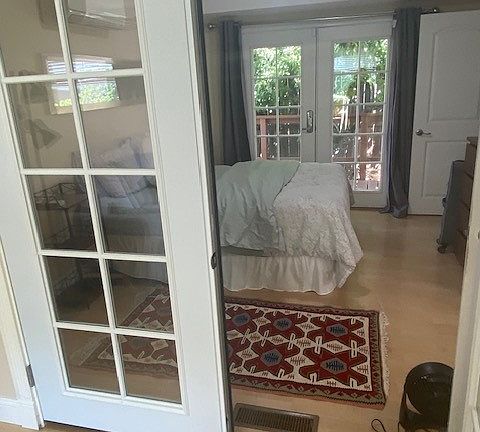 French door separates the living room from bedroom. Can be left open or closed.