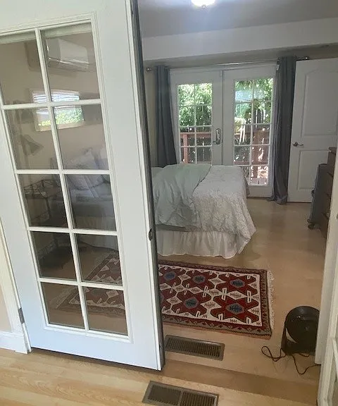 French door separates the living room from bedroom. Can be left open or closed.