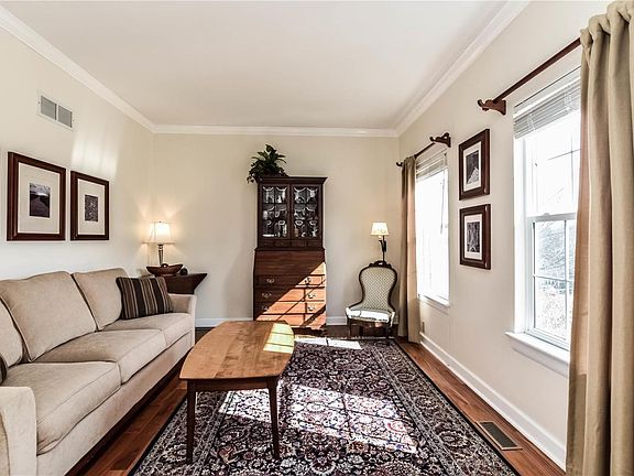 Warm wood floors and tons of natural light fill the formal living room