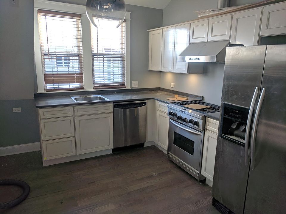 Large island kitchen with stainless Kitchenaid appliances.