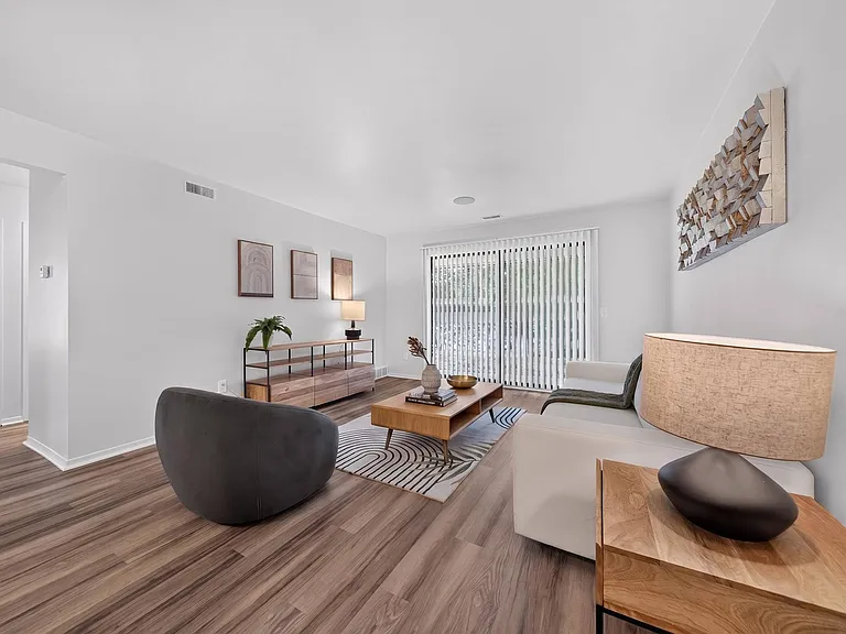Spacious Living Room with Sliding Glass Door at Lakeside Village Apartments Clinton Township MI