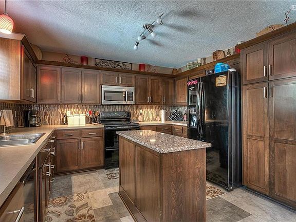 Beautiful custom cabinetry, granite counter top on the center island, new backsplash, new dishwasher, new floors.