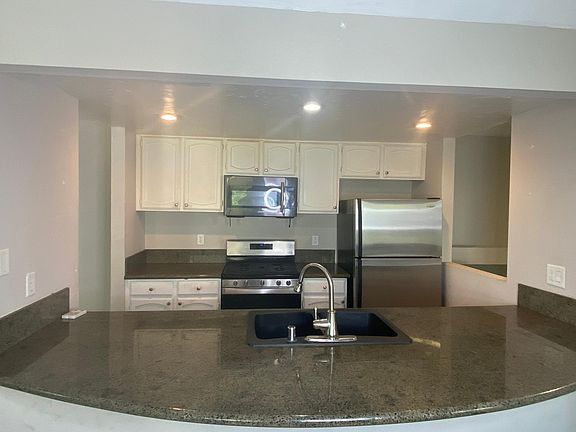Kitchen with extended bar top. Barstools included.