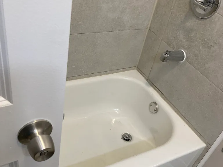 Heated bathroom with new tub, toilet and vanity.