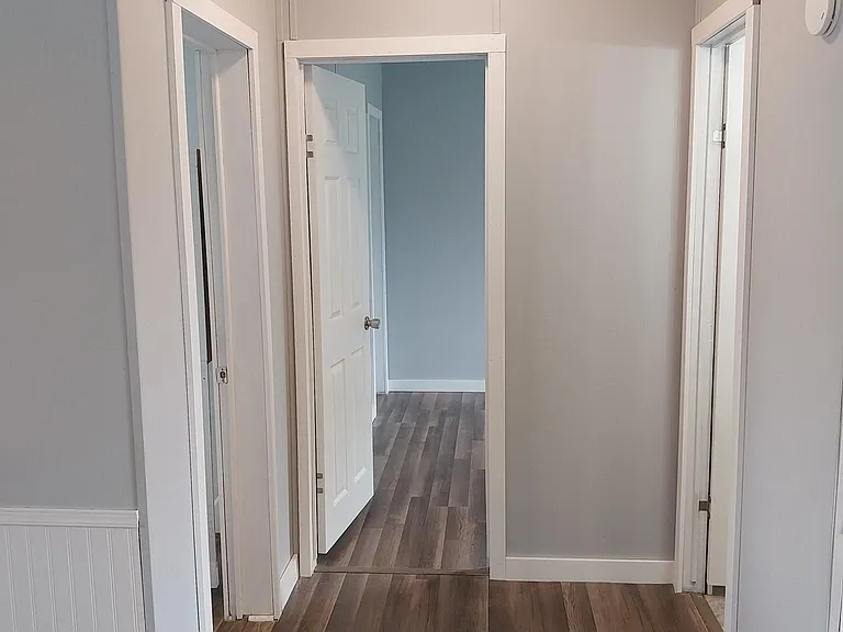Hallway leading to guest bedrooms and bathroom