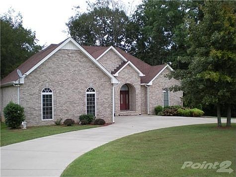 Circular concrete drive in front of property for your convenience.