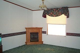 The small fireplace adds additional warmth to the spacious living room.
