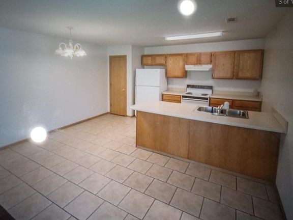Kitchen and dining area. Pantry next to refrigerator.