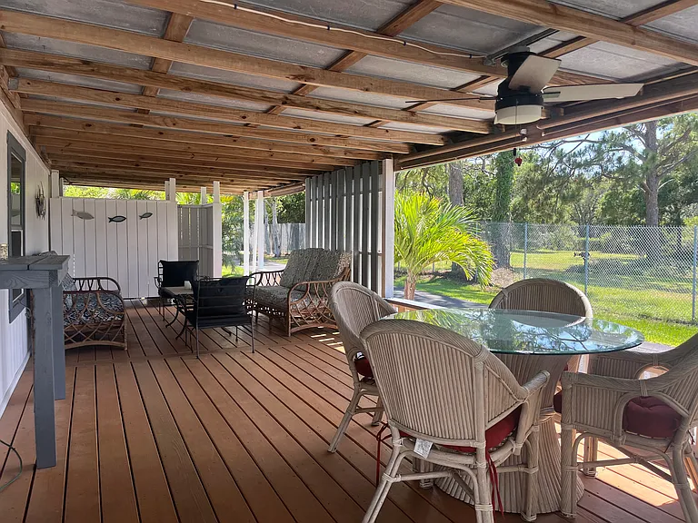 A look back to the outdoor lounging area with seating for eight. Notice the walk-in outdoor shower in the background.