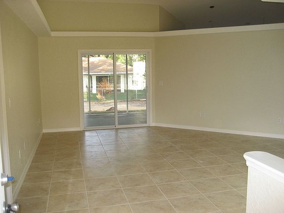 front door looking in to living Rm with planter shelves and vaulted ceiling 