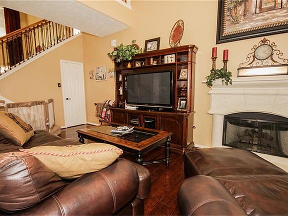 Another view of the den, fireplace and stairs