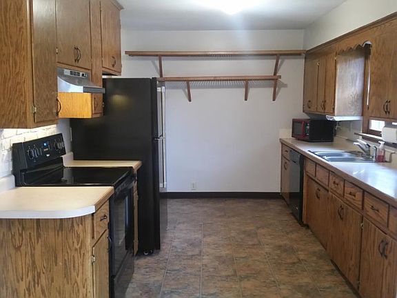 Kitchen is open to the dining room with new floor and applia