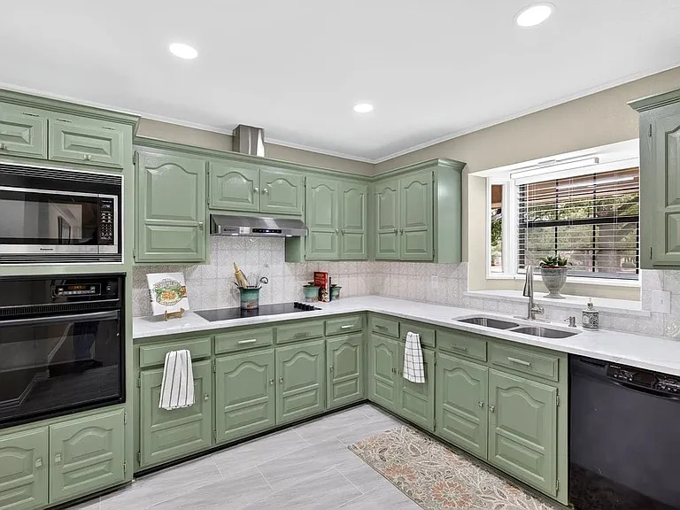 Color drenched kitchen with beautiful view to the park like front yard.