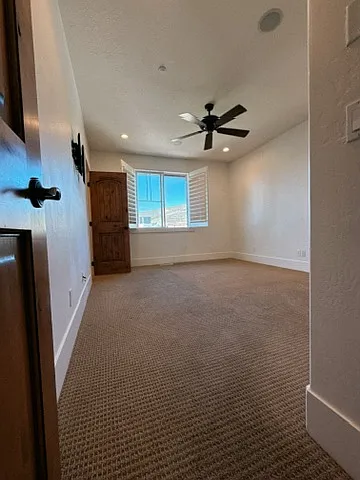 Upper Level - Master bedroom Entry perspective with excellent natural light, plantation shutters, and a classic ceiling fan.