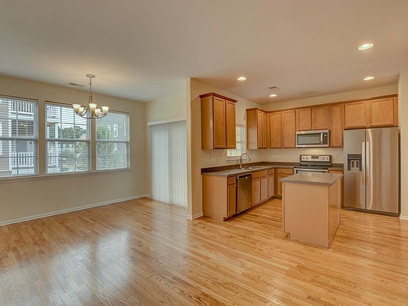 Open floor plan kitchen with modern appliances and enough room for a full dining area or to place comfy furniture for loved ones to share meal prep time together.