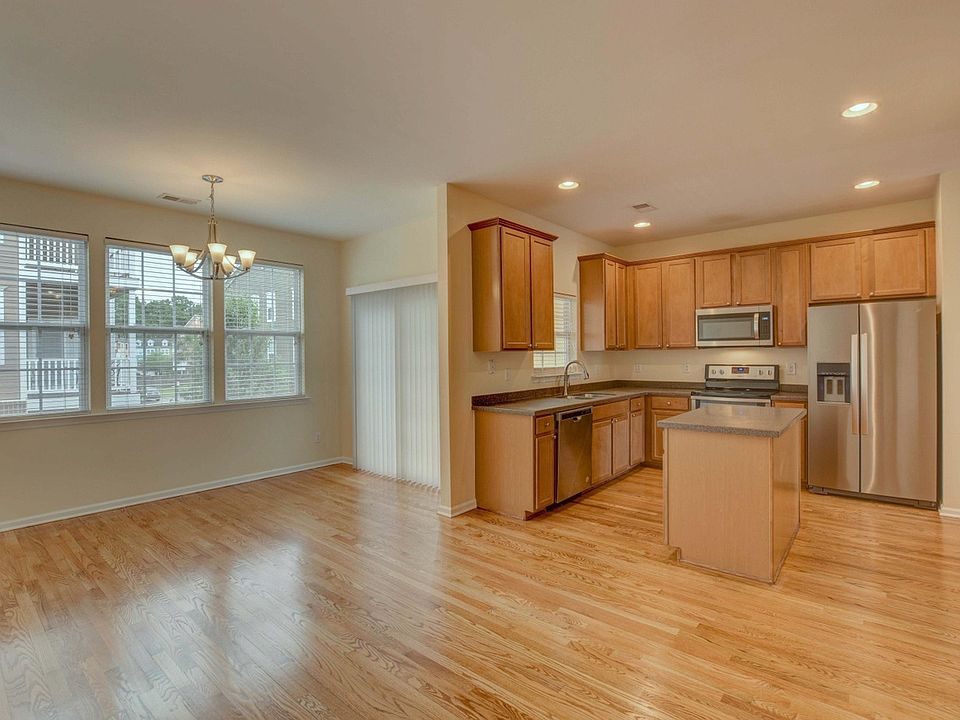Open floor plan kitchen with modern appliances and enough room for a full dining area or to place comfy furniture for loved ones to share meal prep time together.