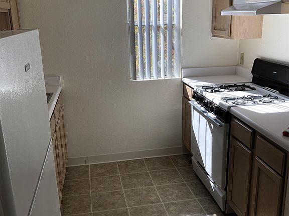 Kitchen area with the window with newer gas stove, fridge and dishwasher