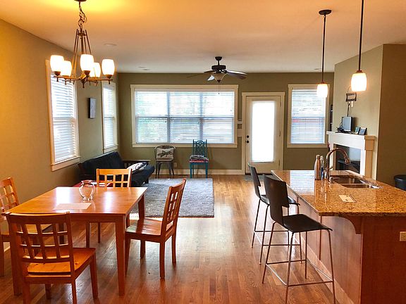 Large open kitchen, dining and den with access to back deck