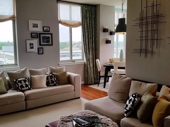 Open Living room with lots of sunshine and custom window treatments