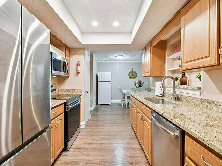 Updated kitchen with granite counter tops and stainless steel appliances