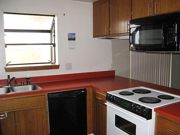 Kitchen with appliances, garbage disposal, and InSinkErator.