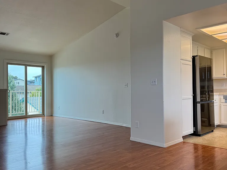 Living Room/Dining (27' x 17' 6") with Vaulted Ceiling flows into Kitchen