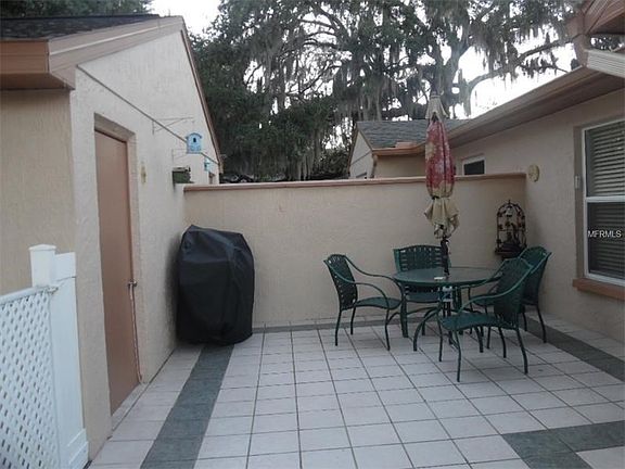 Spacious open patio leads from the front gate to the home