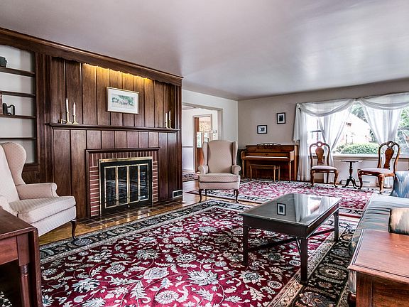 Large living room w/ brick wood-burning fireplace