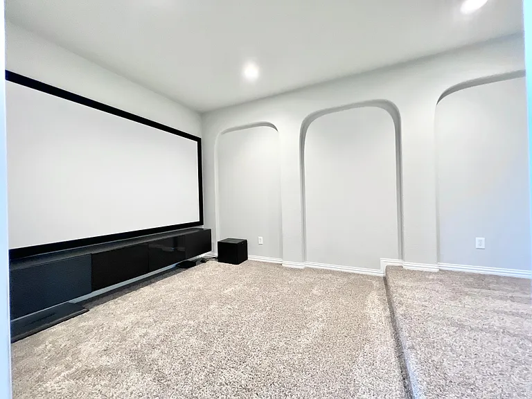 Media room with screen, speaker system and projector
