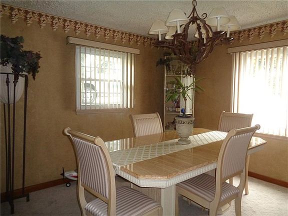Formal Dining Room with lovely Chandelier and window treatments.