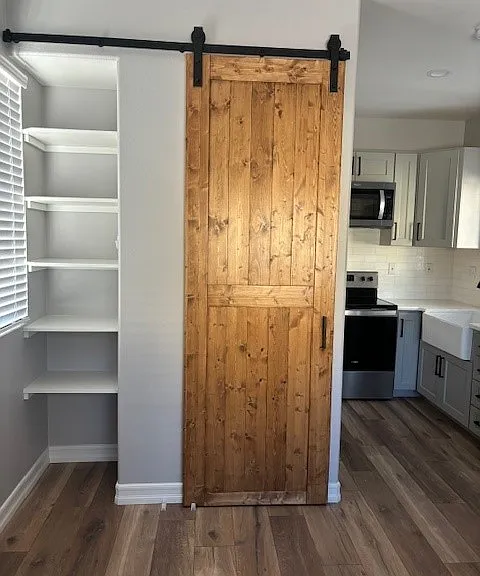 Shelves in living space and door to bathroom.