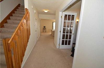 Entry. Welcoming entry; carpeted, with both painted and stained woodwork.