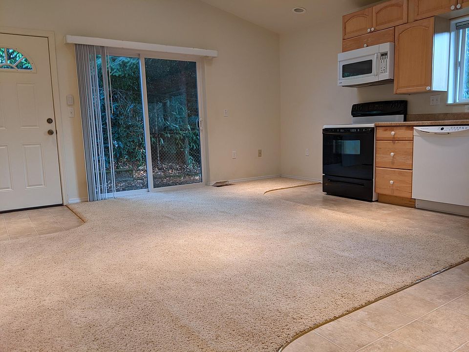 Combined living room and kitchen. Very bright with multiple skylights and windows.