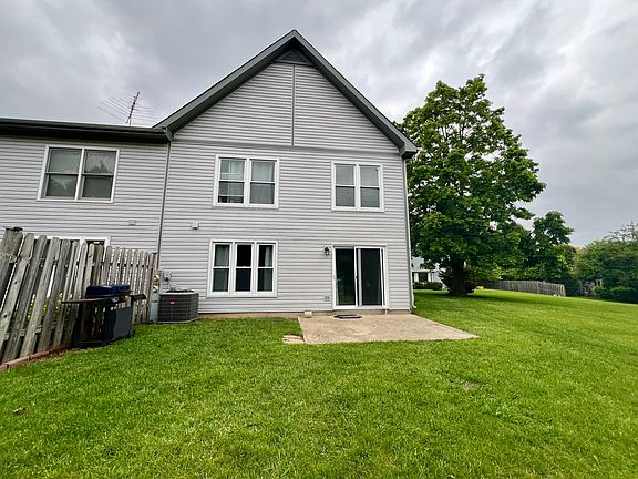 Back of home with one side fence for privacy and large open area