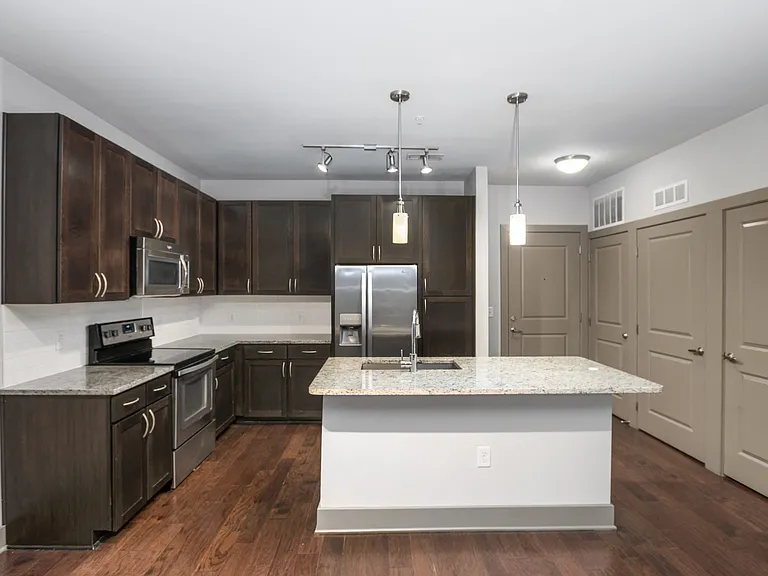 Gourmet Preparation Island with Pendant Lighting in Select Apartments