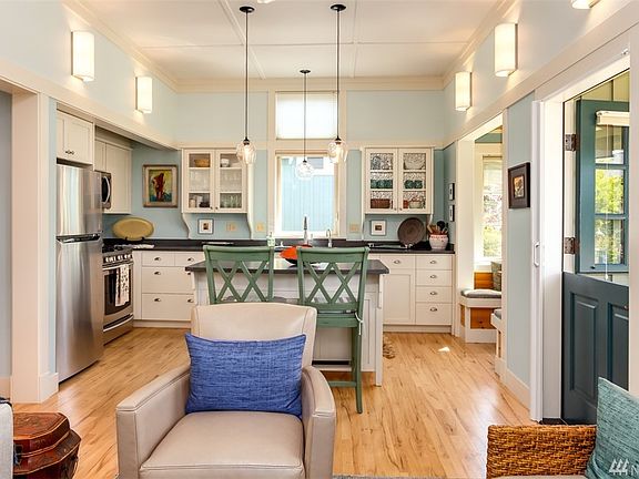 As you enter, floors are hickory, kitchen has new counter tops and appliances.  Custom light fixtures throughout.